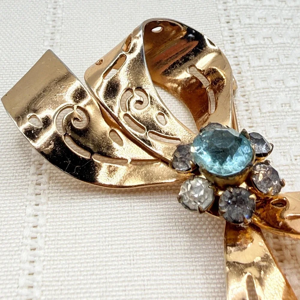 Vintage CORO Gray and Blue Rhinestones Gold Tone Cutout Bow Pin Brooch